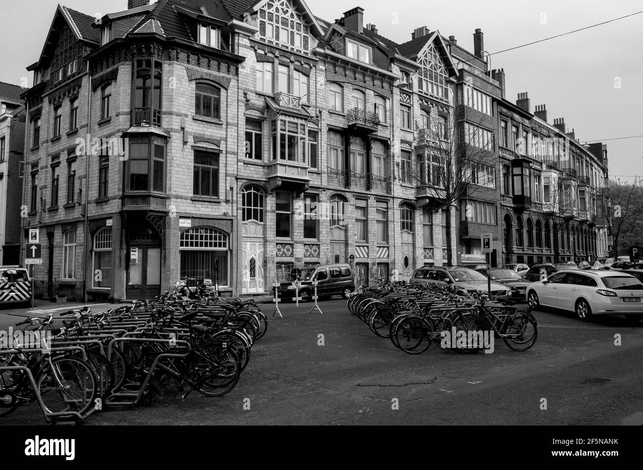 Rows of bicycles parked outside a handsome old building in Koningin Astridlaan, near Citadel Park in Ghent, Belgium. B&W Stock Photo