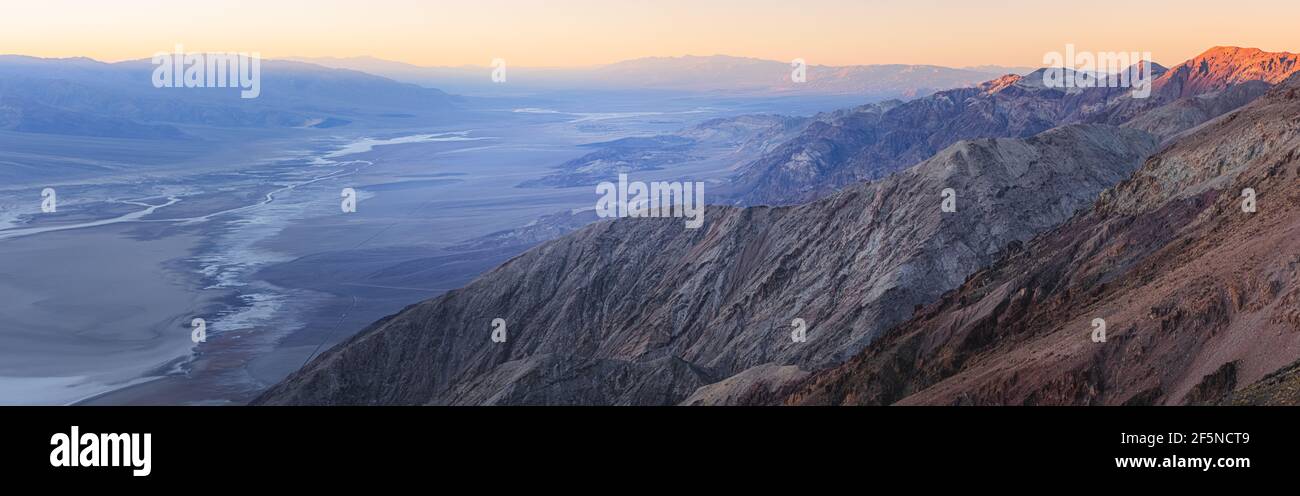 Panorama sunset or sunrise over the desert landscape of Badwater Basin salt flats from Dantes View in Death Valley National Park, California, USA. Stock Photo