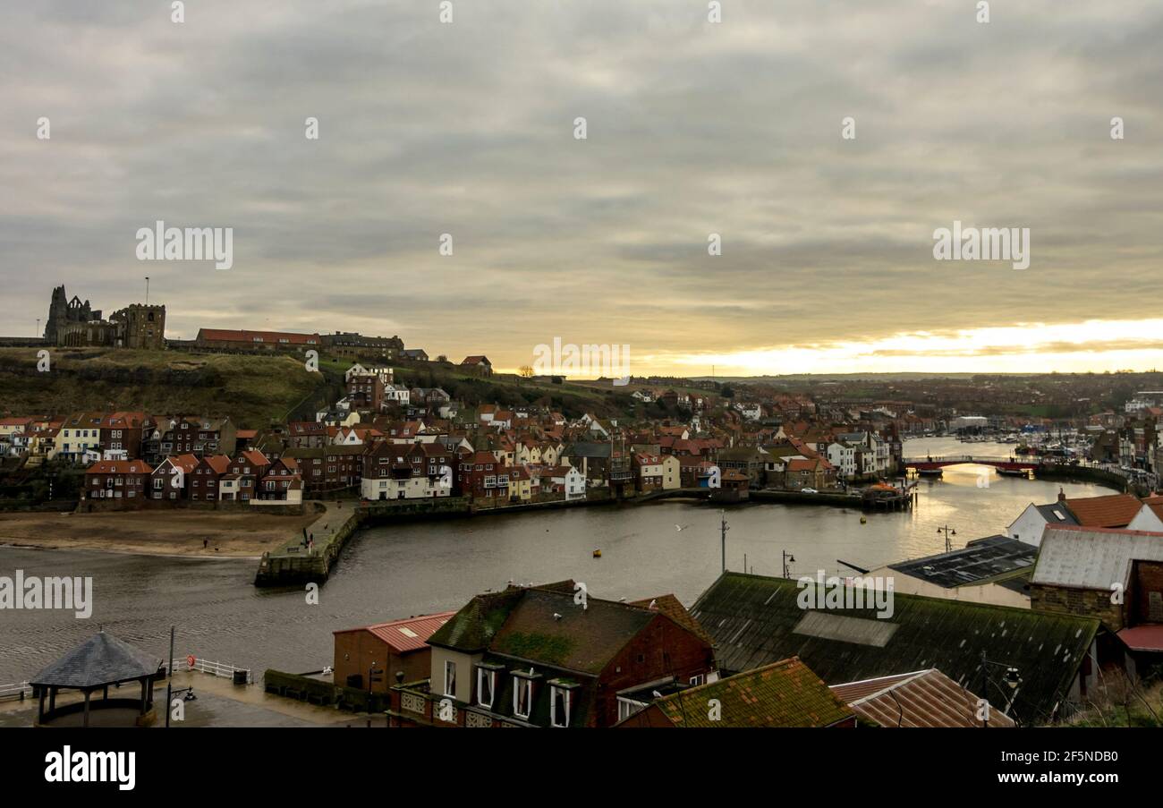A winter sunrise over Whitby Harbour, North Yorkshire, UK with the Abbey in the background. Stock Photo