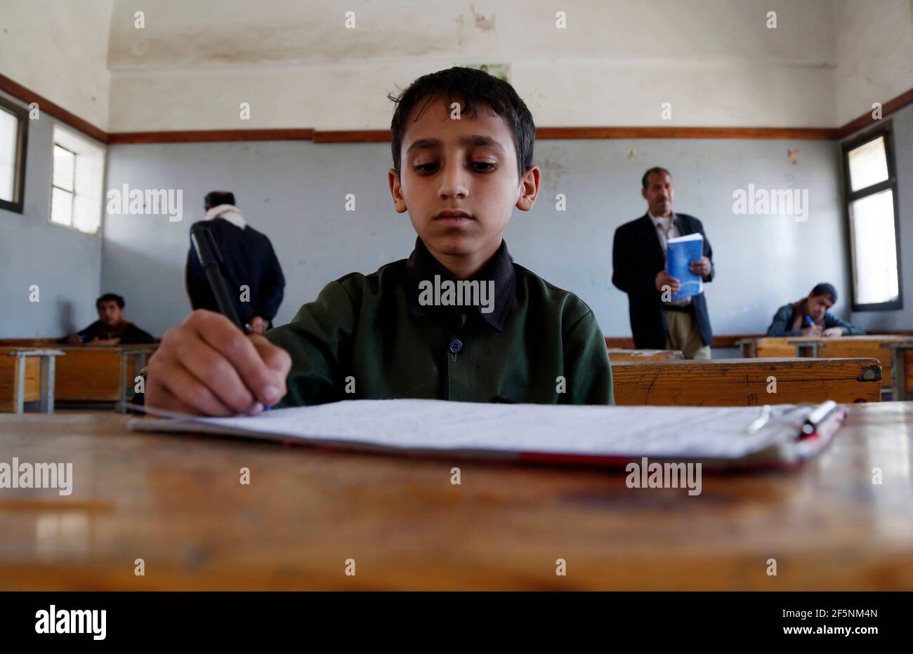 Sanaa, Yemen. 27th Mar, 2021. A child attends the final exam of the semester at a school in Sanaa, Yemen, March 27, 2021. The educational authority in Sanaa, which is controlled by the Houthi rebels, decides to end the current semester a month earlier because of the spread of COVID-19. Credit: Mohammed Mohammed/Xinhua/Alamy Live News Stock Photo