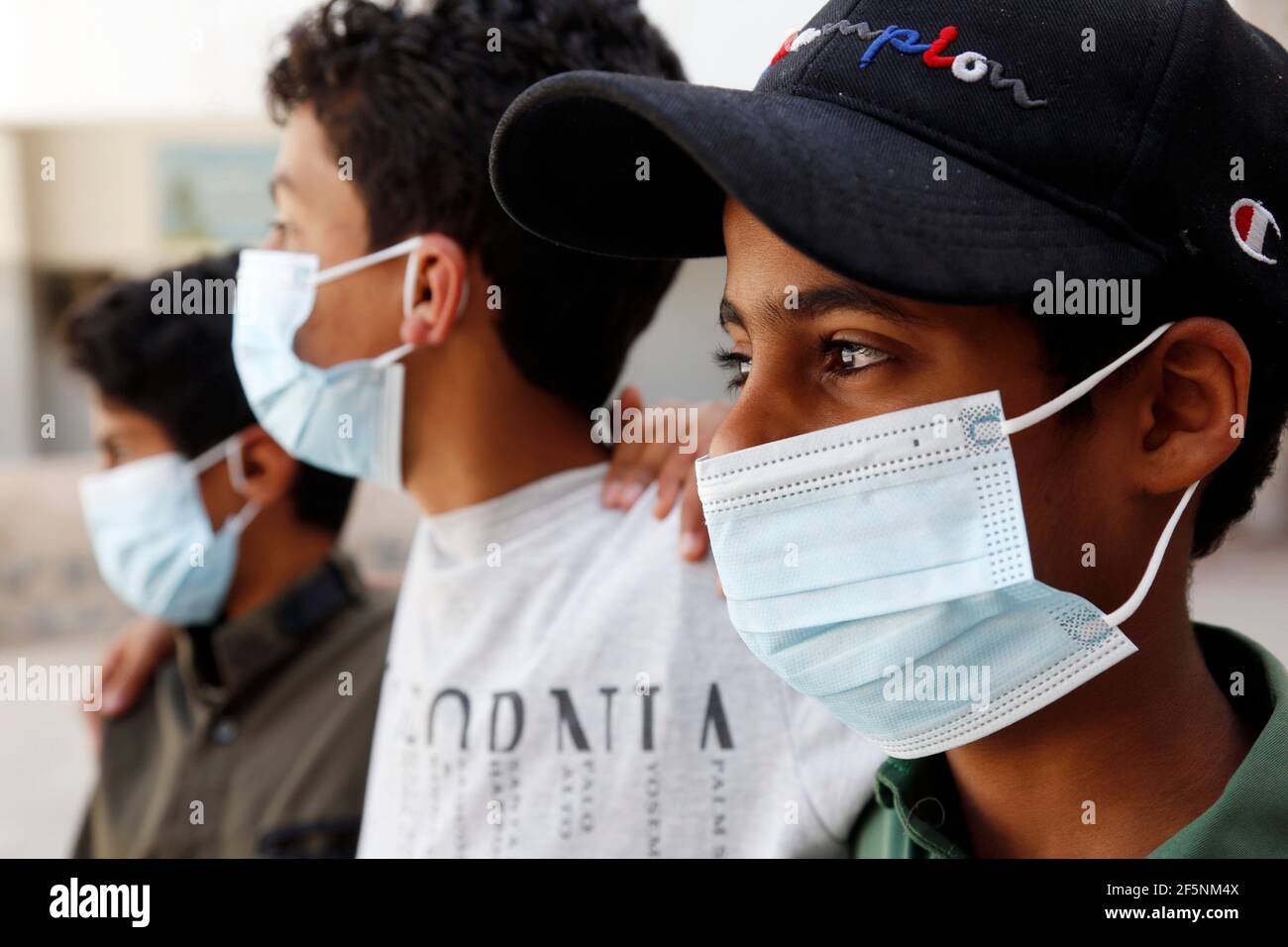 Sanaa, Yemen. 27th Mar, 2021. Children wearing face masks are seen at a school in Sanaa, Yemen, March 27, 2021. The educational authority in Sanaa, which is controlled by the Houthi rebels, decides to end the current semester a month earlier because of the spread of COVID-19. Credit: Mohammed Mohammed/Xinhua/Alamy Live News Stock Photo