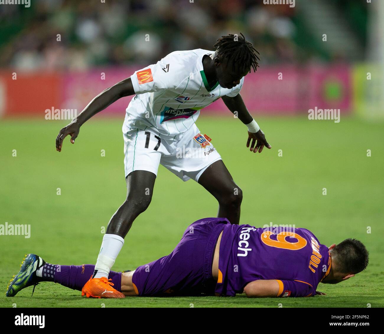 27th March 2021; HBF Park, Perth, Western Australia, Australia; A League Football, Perth Glory versus Newcastle Jets; Kuach Yuel of the Newcastle Jets stands over Bruno Fornaroli Mezza of the Perth Glory after he fouled him in a tackle Stock Photo
