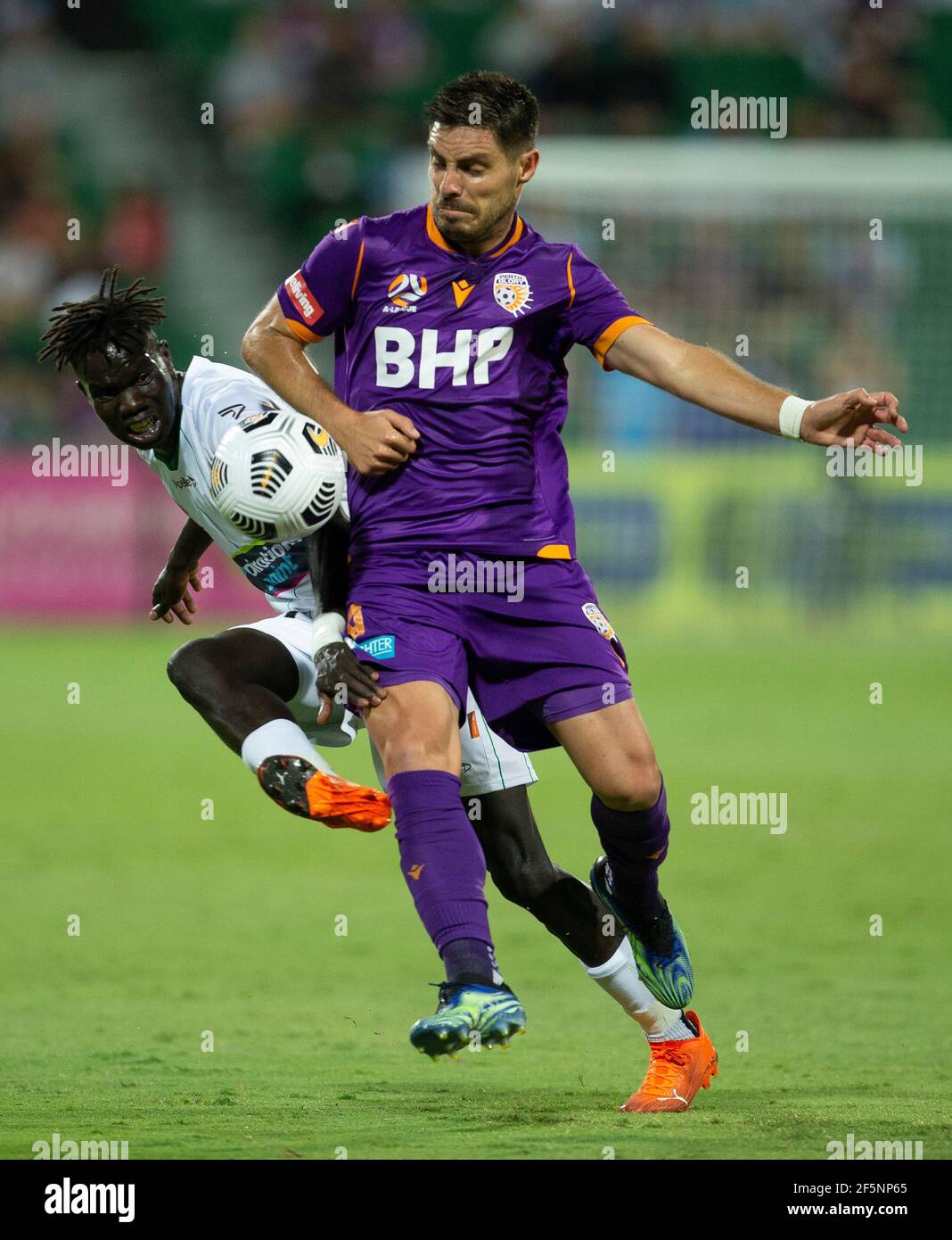 27th March 2021; HBF Park, Perth, Western Australia, Australia; A League Football, Perth Glory versus Newcastle Jets; Bruno Fornaroli Mezza of the Perth Glory challenges for the loose ball against Kuach Yuel of the Newcastle Jets Stock Photo