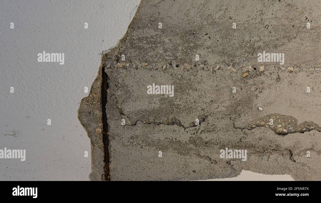Corrosion in concrete creates a cracked and damaged wall Stock Photo