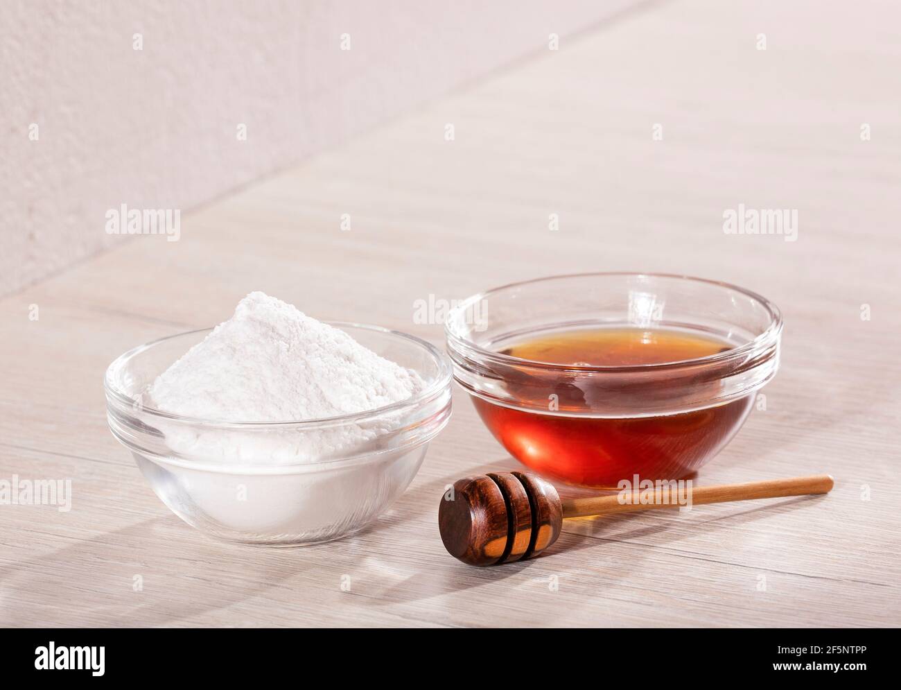 Baking soda and pure honey in glass bowls Text space Stock Photo Alamy