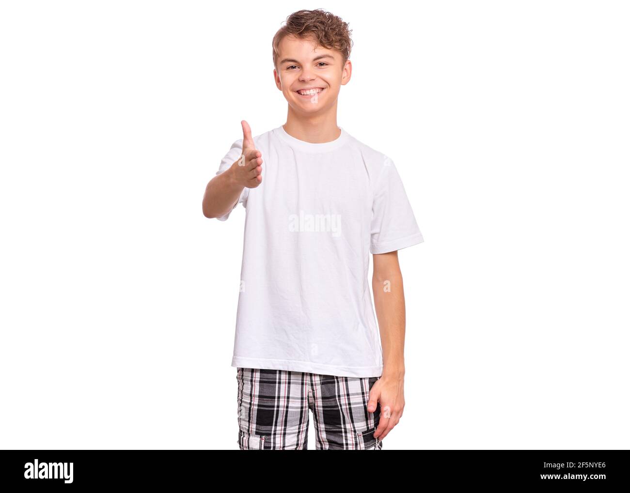 Handsome teen boy stretching his right hand up for greeting, isolated on white background Stock Photo
