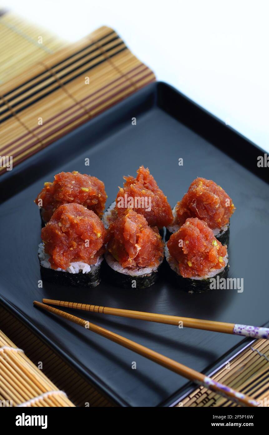 appetizing fish tartare sushi served nicely on a black plate Stock Photo
