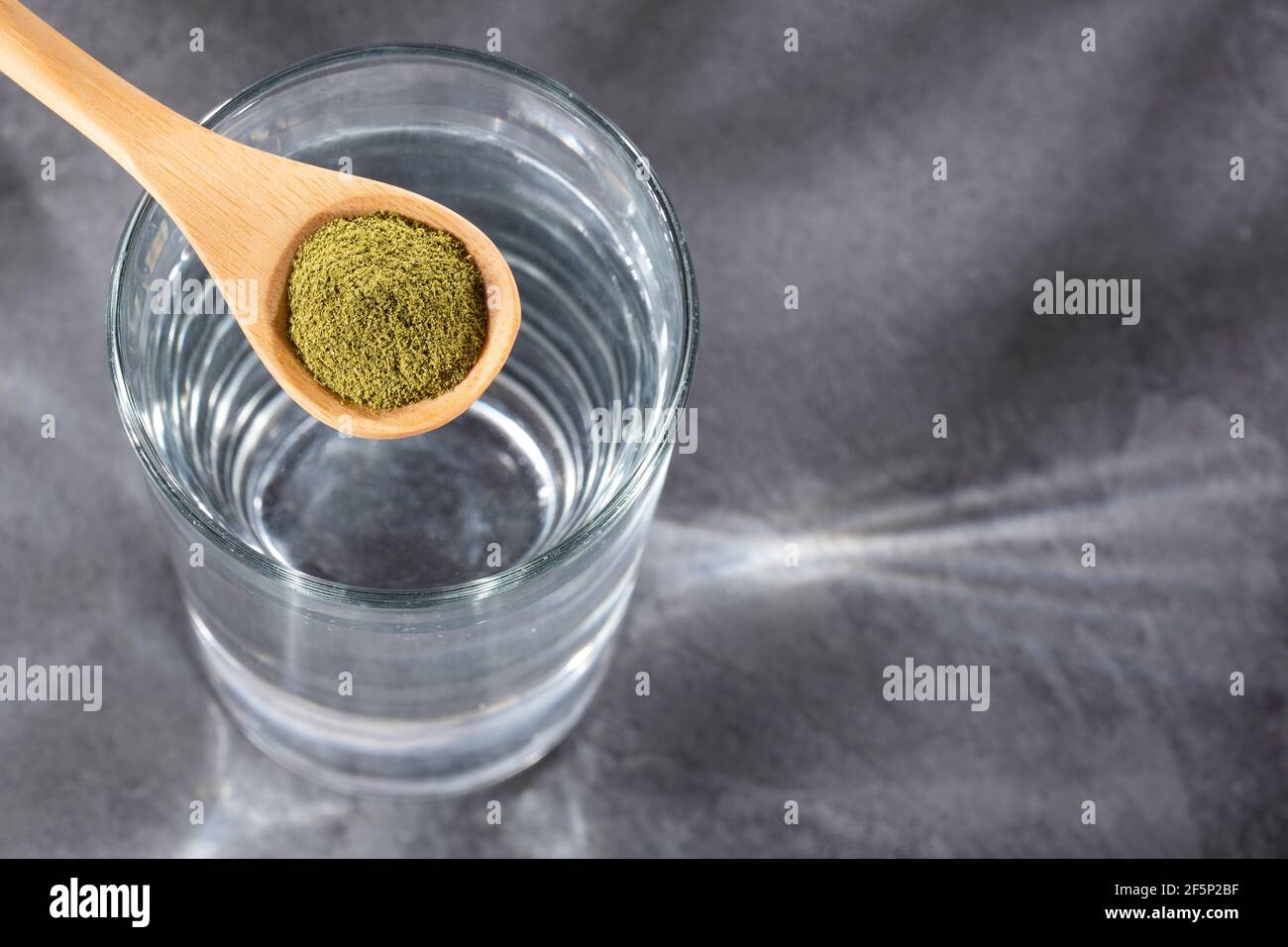 Spoon with moringa powder to mix with water Moringa oleifera Stock