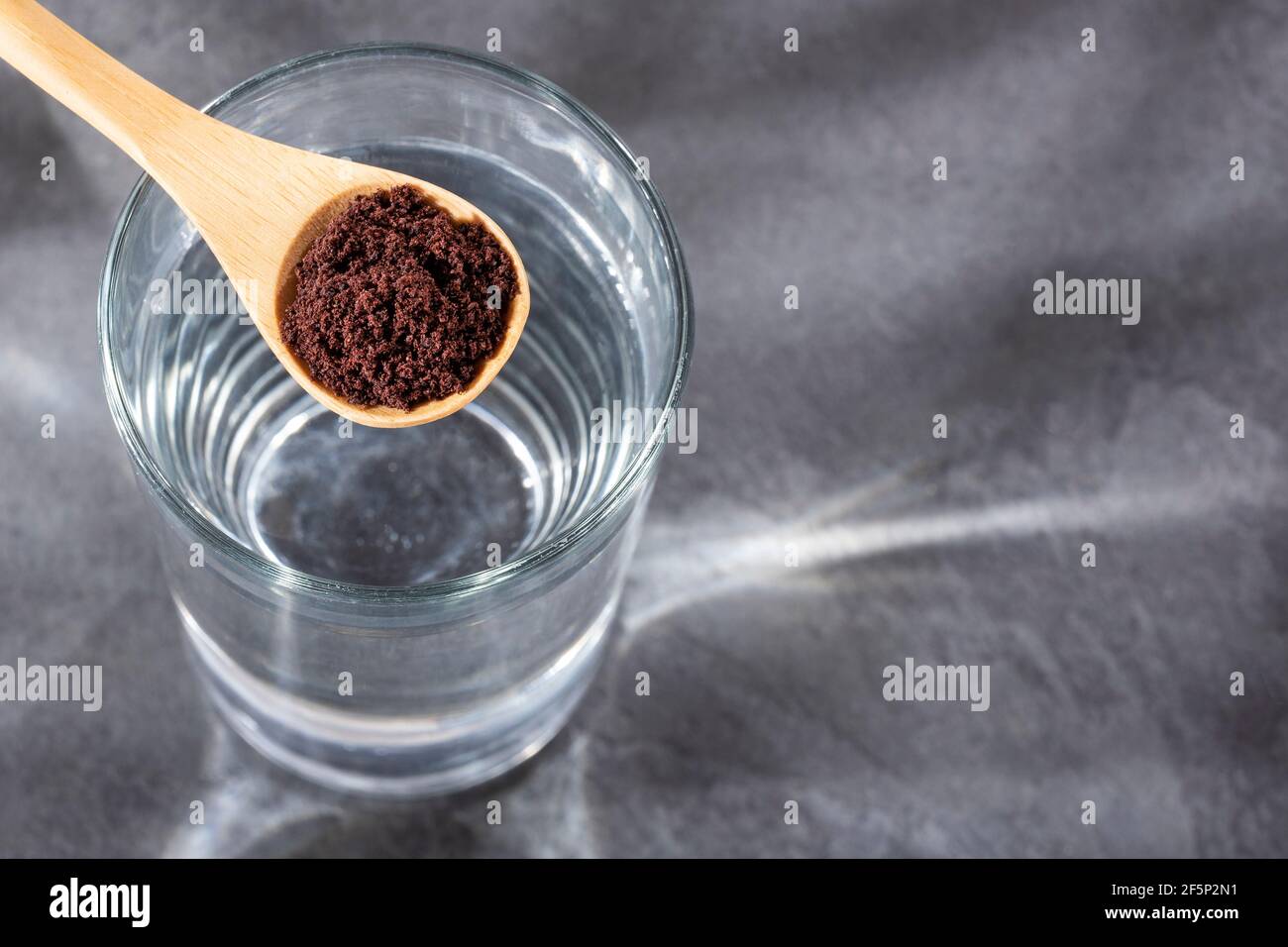 Spoon with acai powder to mix with water Euterpe oleracea Stock Photo