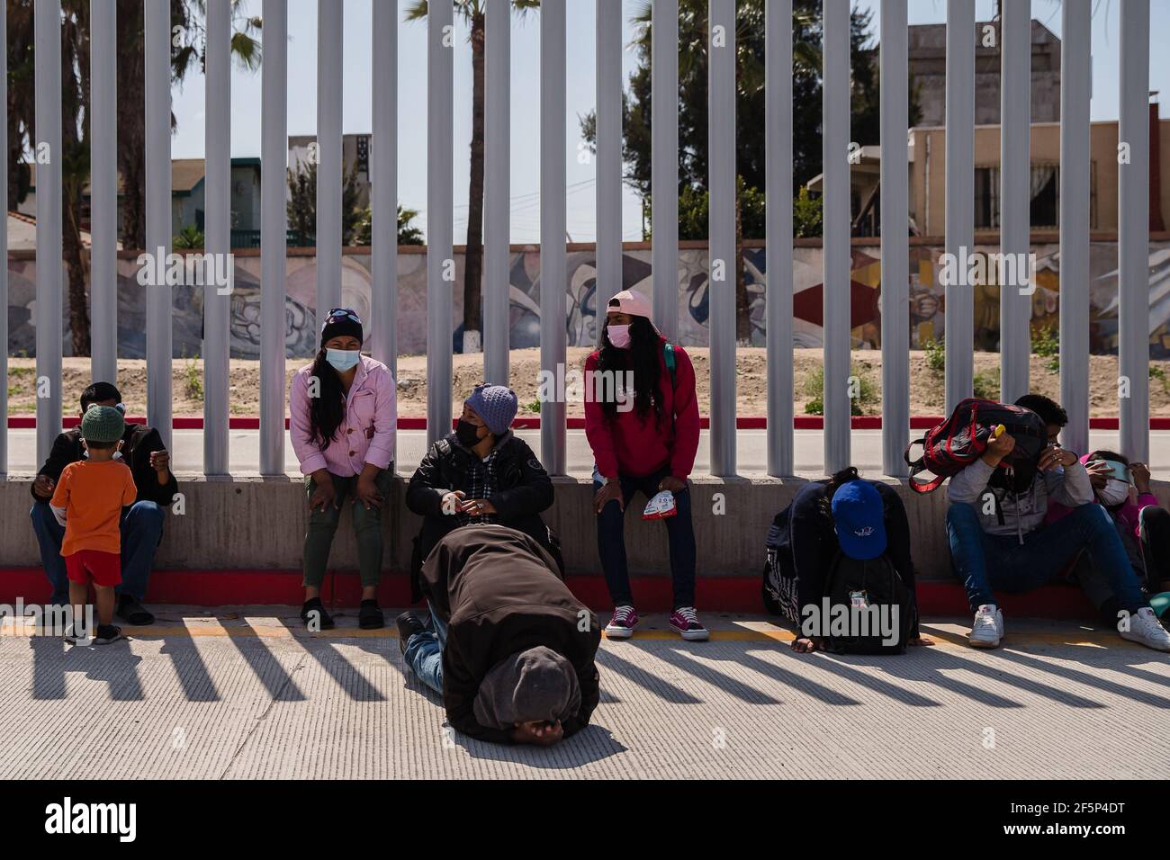 Tijuana, Mexico. 27th Mar, 2021. Asylum seekers demonstrate at the San Ysidro border crossing in Tijuana, Mexico praying and listening to speeches on Friday, March 26, 2021. Many of the them have been sleeping in tents at El Chaparral plaza in hopes of being able to seek asylum in the United States. Photo by Ariana Drehsler/UPI Credit: UPI/Alamy Live News Stock Photo