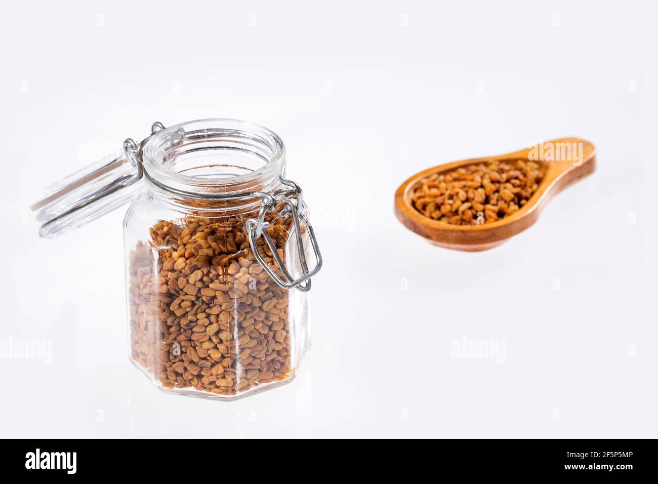 Dried fenugreek seeds in the jar - Trigonella foenum-graecum Stock Photo