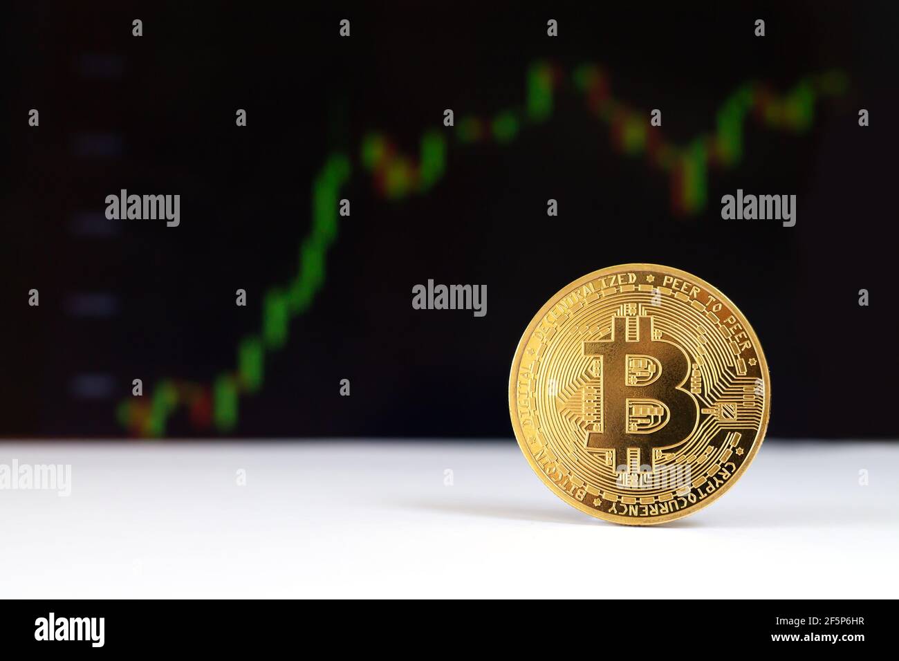 One bitcoin virtual cryptocurrency on chart background close-up Stock Photo