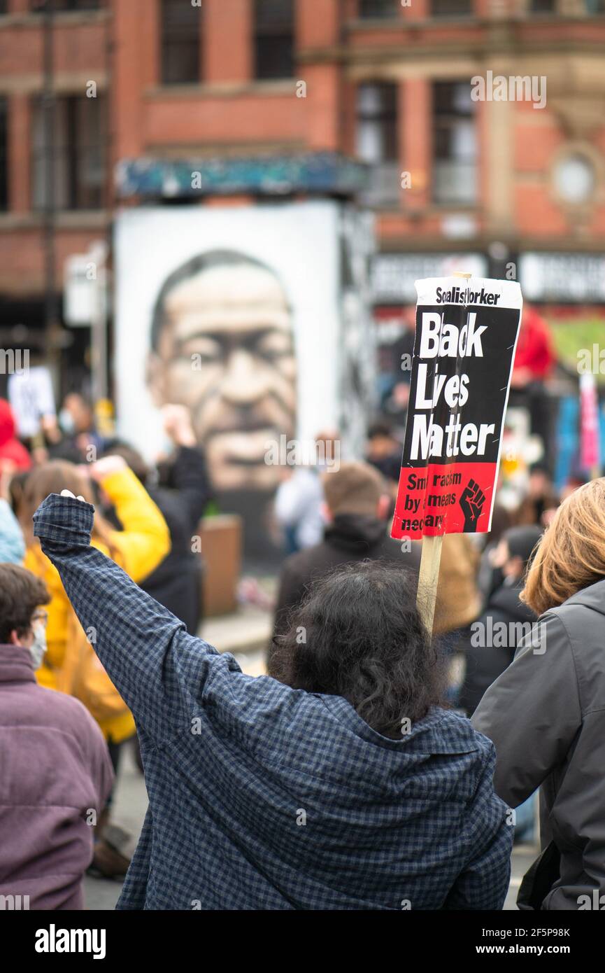 MANCHESTER, UK Protesters 'take a knee' and genuflect in front of the George Floyd mural in Stevenson Square at the 'Kill The Bill' protest in Manchester city centre on Saturday 27th March 2021. (Credit: Pat Scaasi | MI News) Credit: MI News & Sport /Alamy Live News Stock Photo