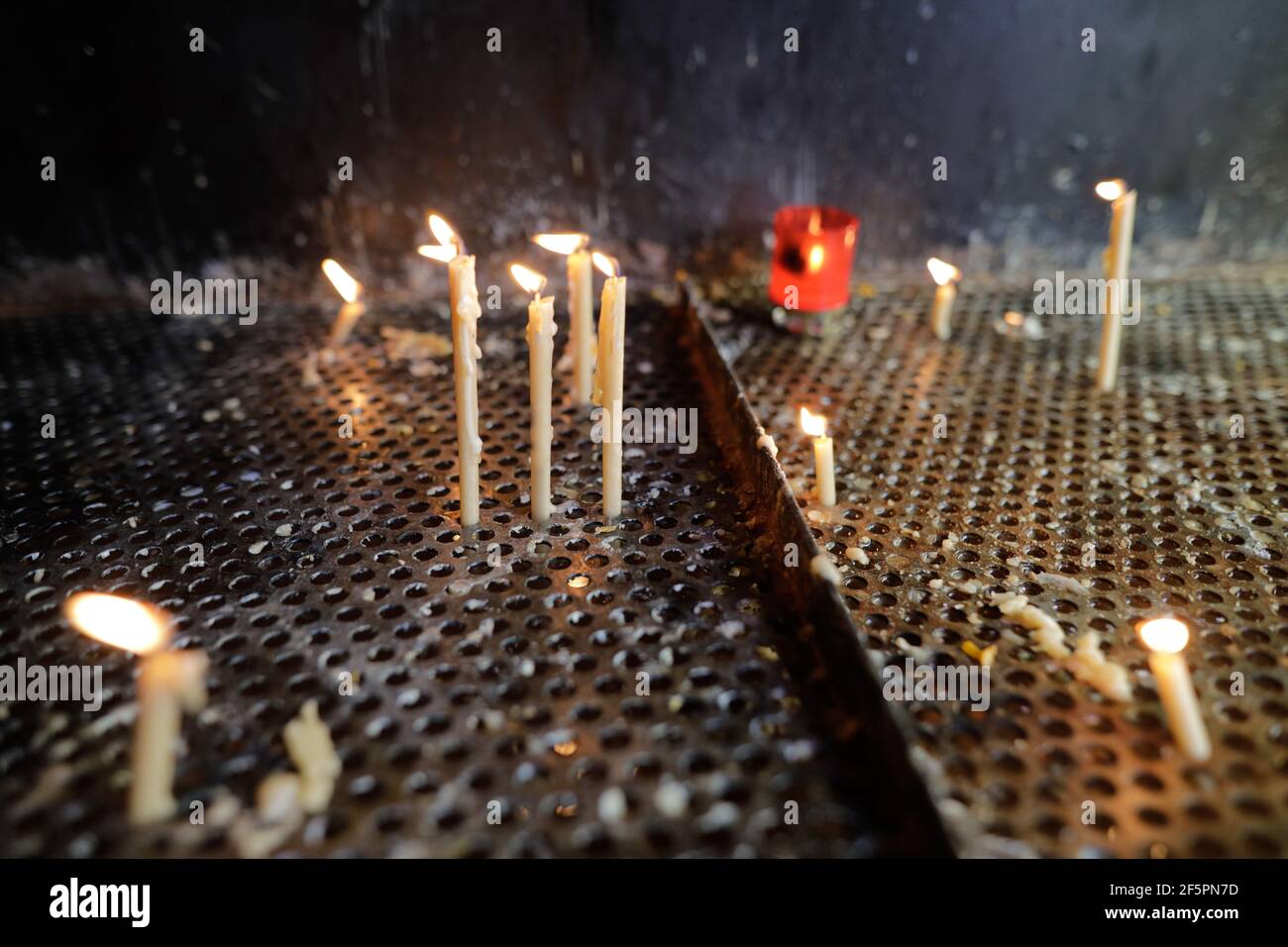 Details with candles lit inside an Christian Orthodox church for the