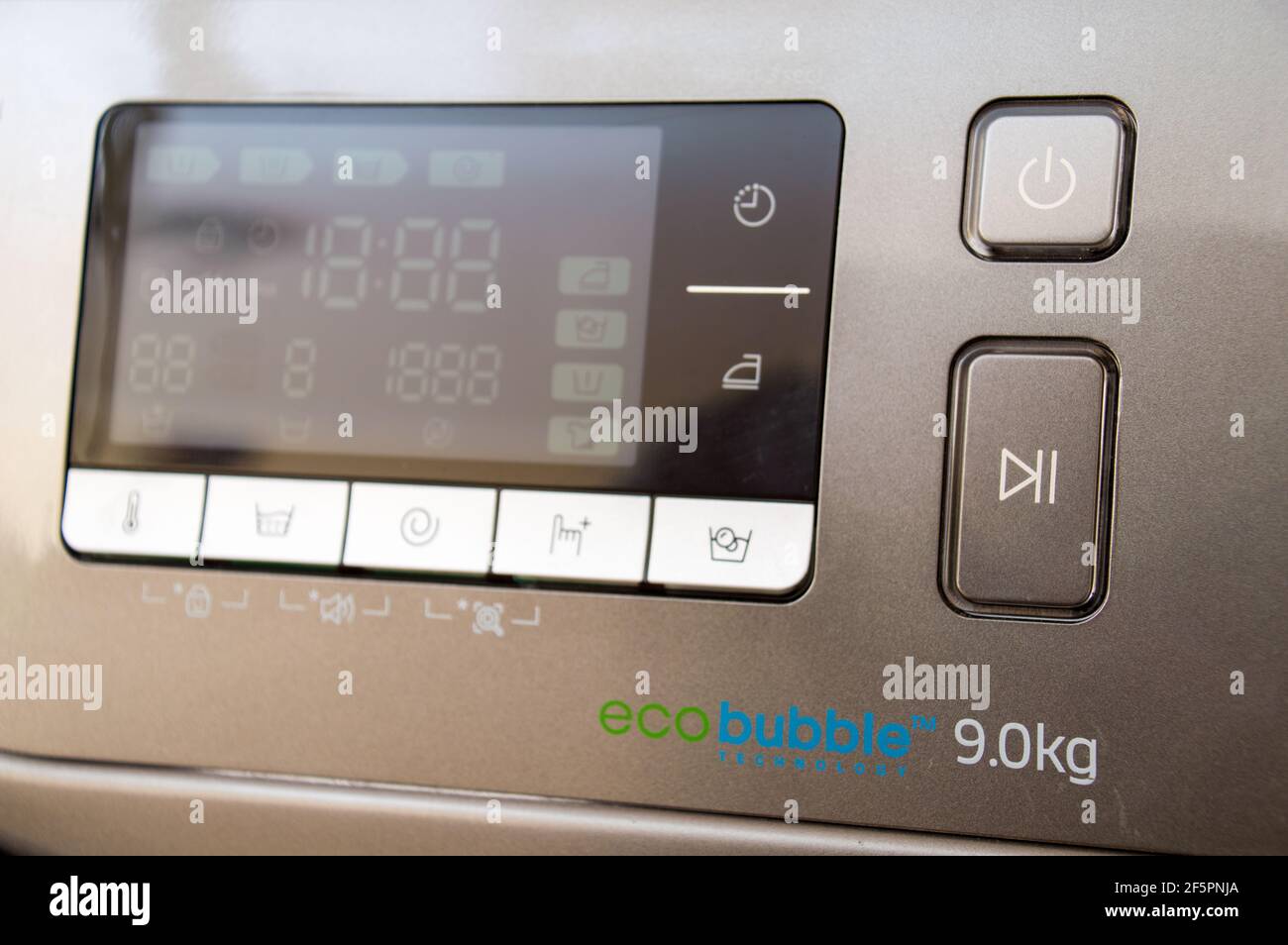 Washing machine control programming panel with round dial and buttons ...