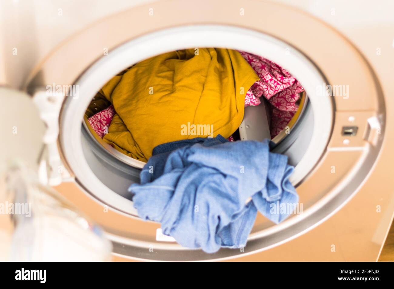 Washing machine with clothes inside ready to be washed Stock Photo Alamy