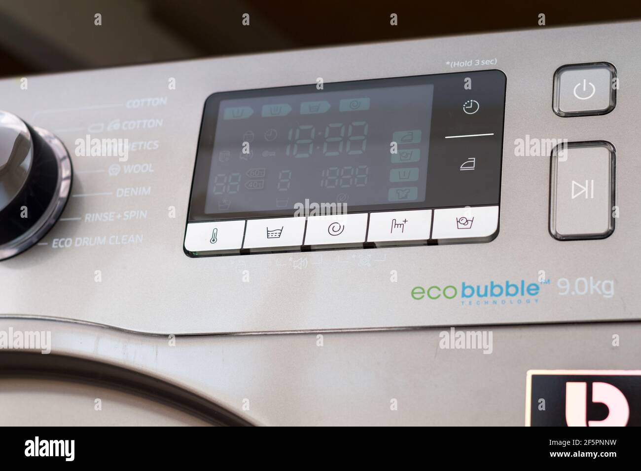 Washing machine control programming panel with round dial and buttons ...