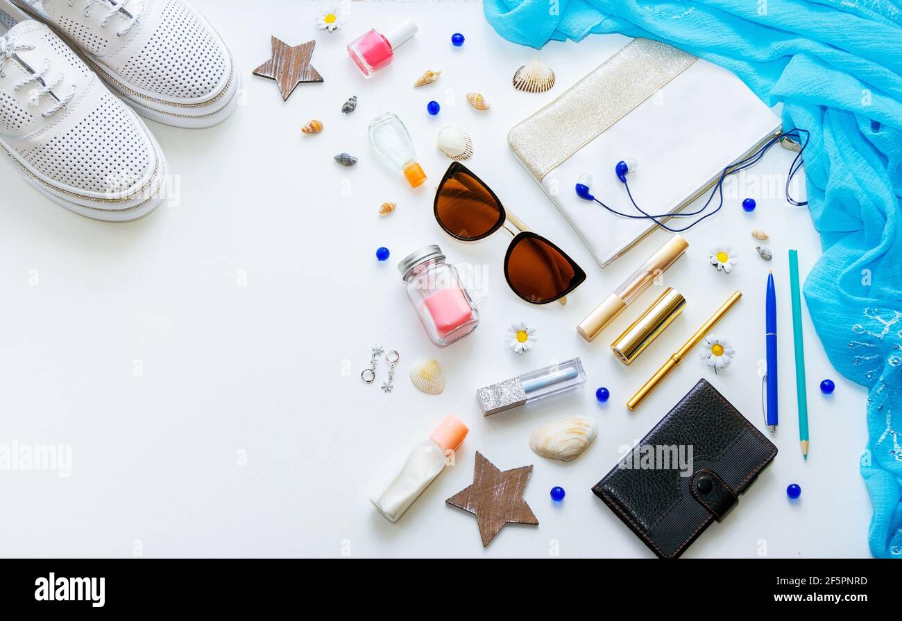 Outfit of young woman or modern teenager girl on white background - shoes, cosmetic and lifestyle accessories. Flat lay objects. Stock Photo