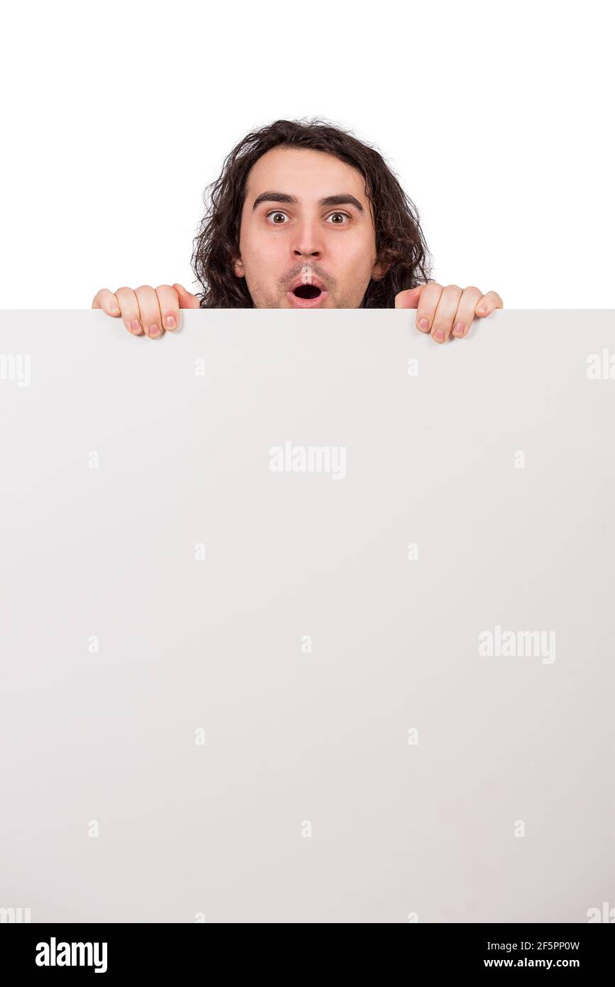 Positively surprised young man, long curly hair style, staring with big  eyes and mouth open, behind a big, blank announcement banner. Amazed guy,  asto Stock Photo - Alamy