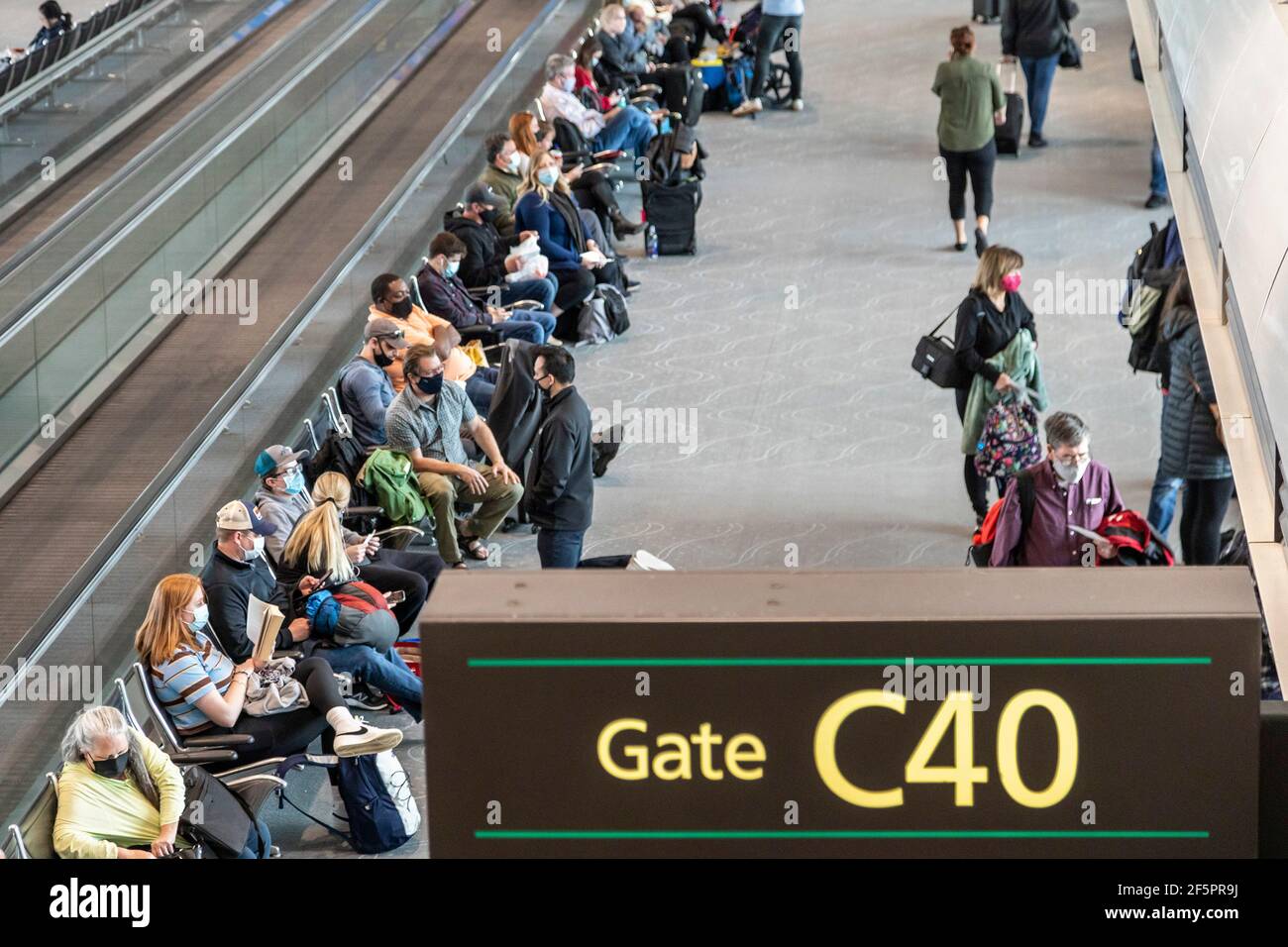 Denver, Colorado - Passengers wait for their planes at Denver International Airport. Travel has increased with Americans' hope that the coronavirus pa Stock Photo