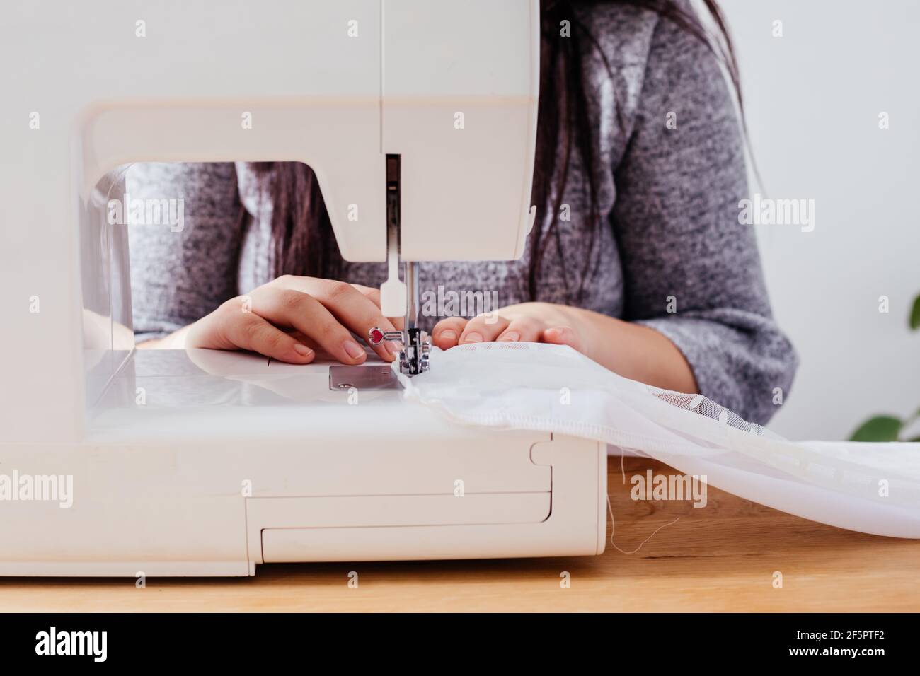 Wedding dressmaker altering white vintage wedding dress Stock Photo Alamy