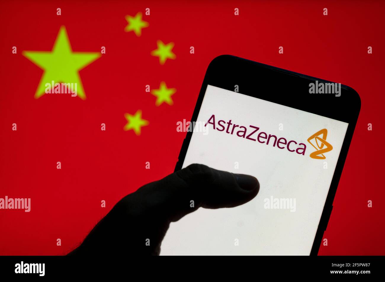 In this photo illustration, the British-Swedish multinational pharmaceutical and biotechnology company AstraZeneca logo seen on an Android mobile device with People's Republic of China flag in the background. Stock Photo