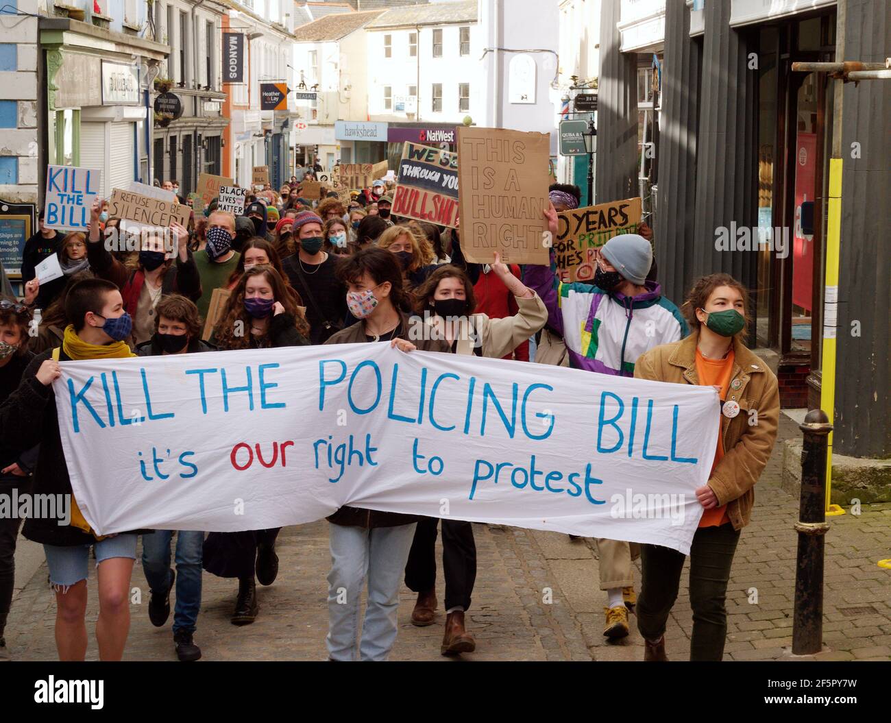 A Kill the bill demonstration and March involving several hundred protesters happens at The Moor square in Falmouth, After speakers finished, a march 1.5 miles through the center of town to Discovery Quay took place for further speeches. The protest in breach of Covid rules was policed at a distance by Devon and Cornwall officers. The proposed Police, crime and sentencing and courts bill could cause serious limitations to protesters deemed to be causing serious disruption. Falmouth. Cornwall, England, 27th March 2021, Credit: Robert Taylor/Alamy Live News Stock Photo