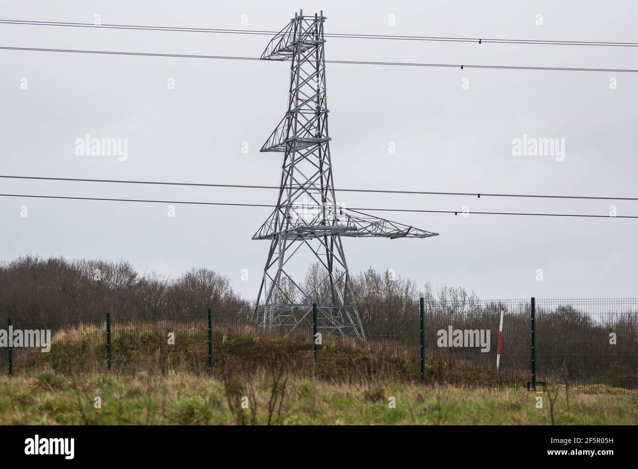 Harefield, UK. 18th March, 2021. A part-assembled pylon stands close to the former site of Dews Farm, which had been demolished earlier in the day. Dews Farm was visited by Queen Elizabeth I in 1602 and was the birthplace of Victoria Cross holder Cecil John Kinross in 1896. Credit: Mark Kerrison/Alamy Live News Stock Photo