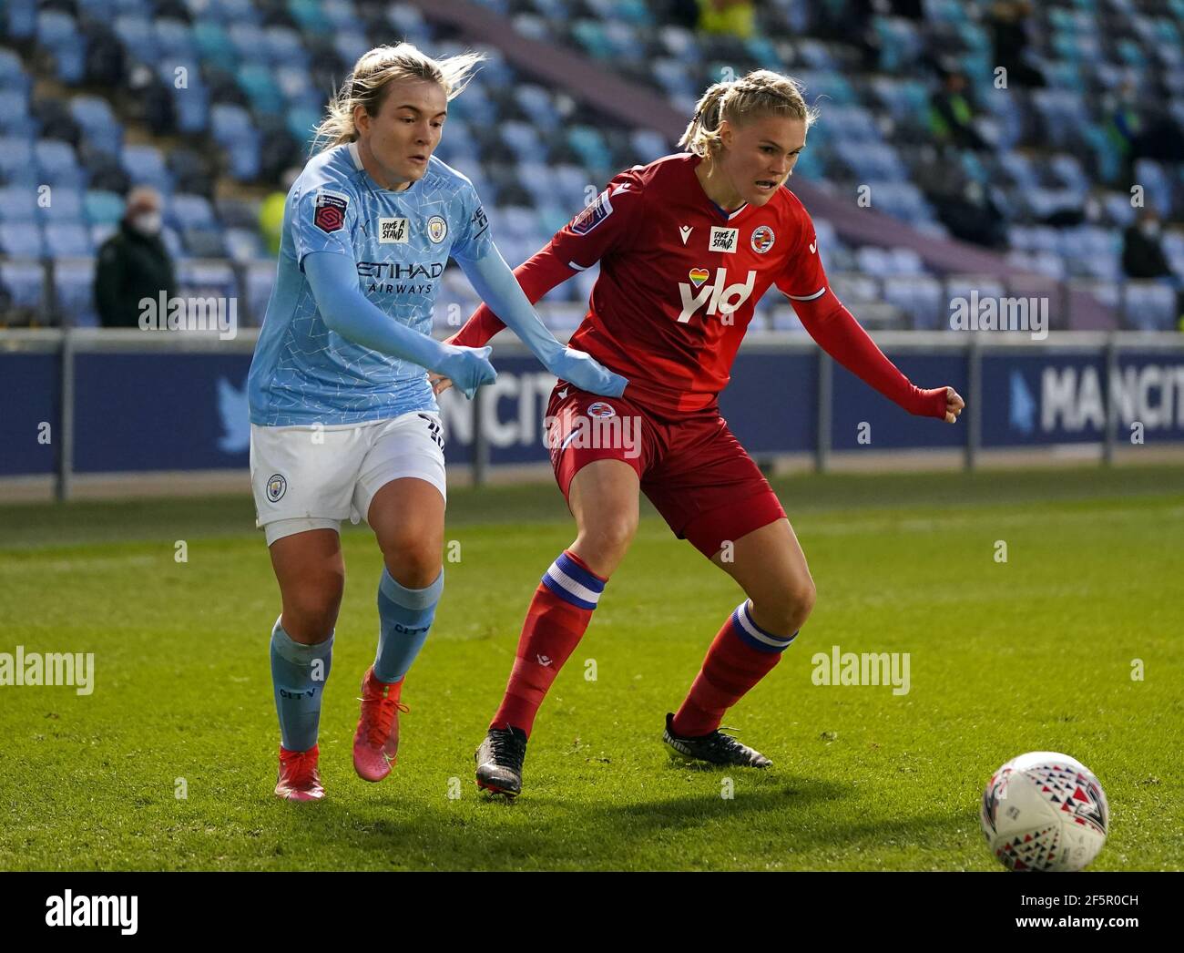 Manchester City's Lauren Hemp (left) and Reading's Kristine Leine battle for the ball during the FA Women's Super League match at the Academy Stadium, Manchester. Picture date: Saturday March 27, 2021. Stock Photo