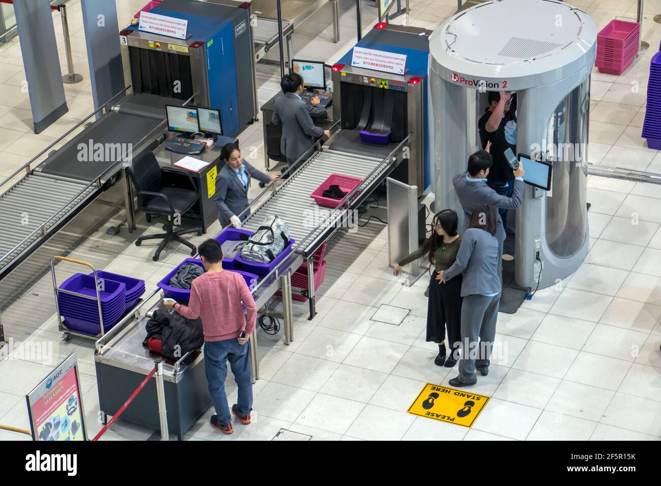 BANGKOK, THAILAND, NOV 27 2018, Control passengers and his baggage at the airport. Security officers at the airport works at body scanner for checked Stock Photo