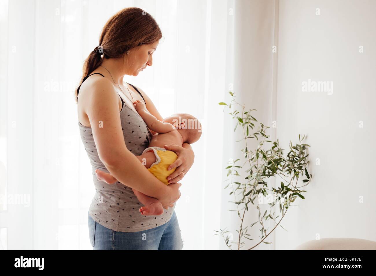 Woman in postpartum depression feeling unemotional and exhausted Stock Photo