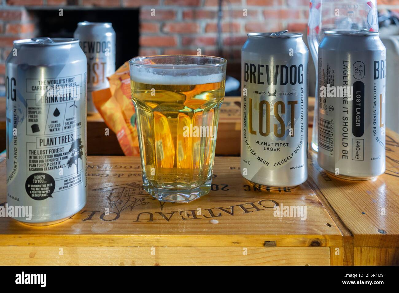 Cans and a glass of Brew Dog Lost Lager, a German style pilsner brewed using wind power and is the world's first carbon negative beer Stock Photo