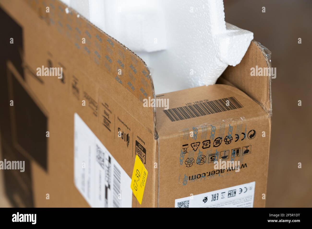 Closeup on a cardboard box for an ACER computer screen with expanded polystyrene packaging. Theme: online shopping, waste packaging, consumer culture Stock Photo
