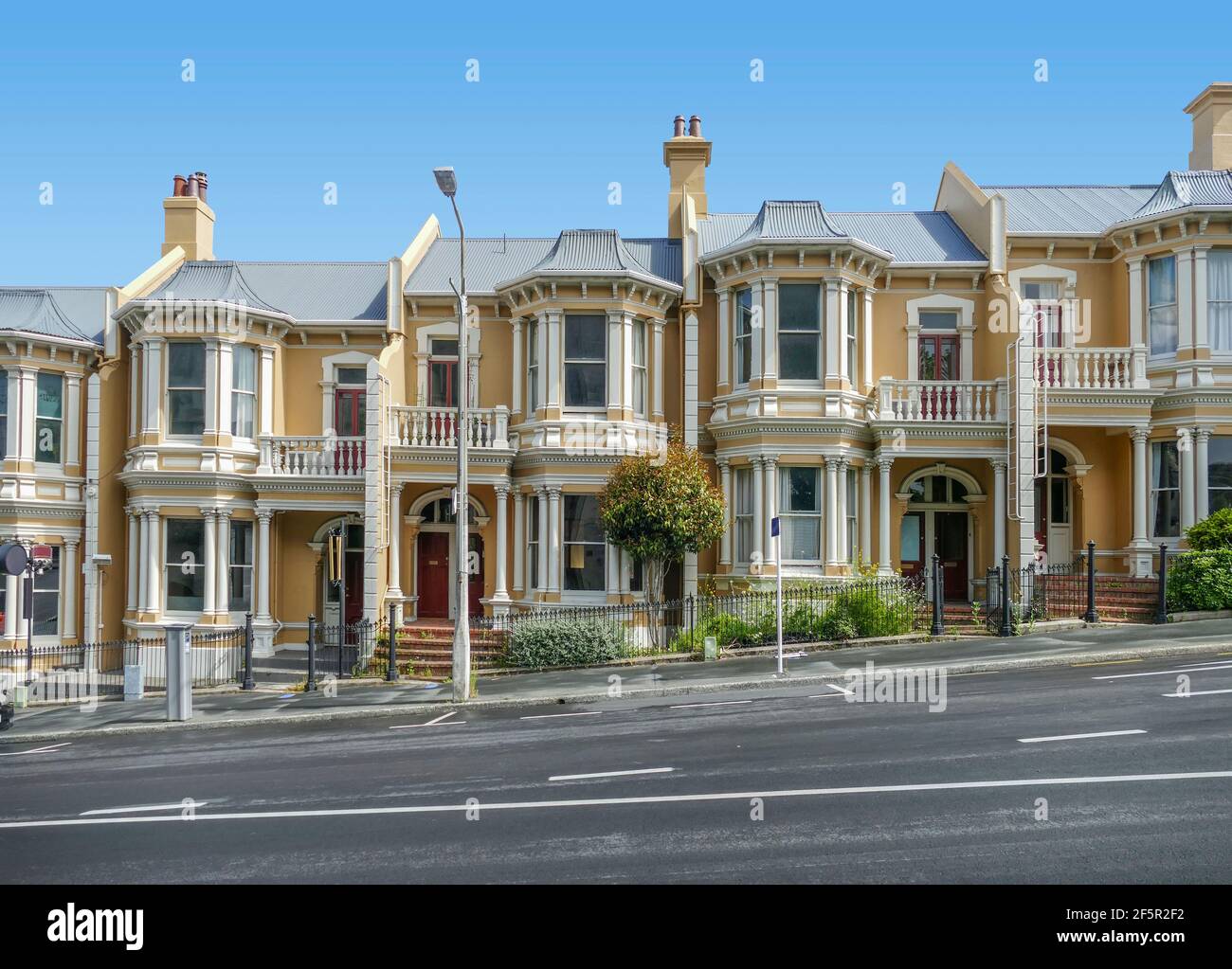 roadside scenery including some houses in Dunedin, a city at the South Island of New Zealand Stock Photo