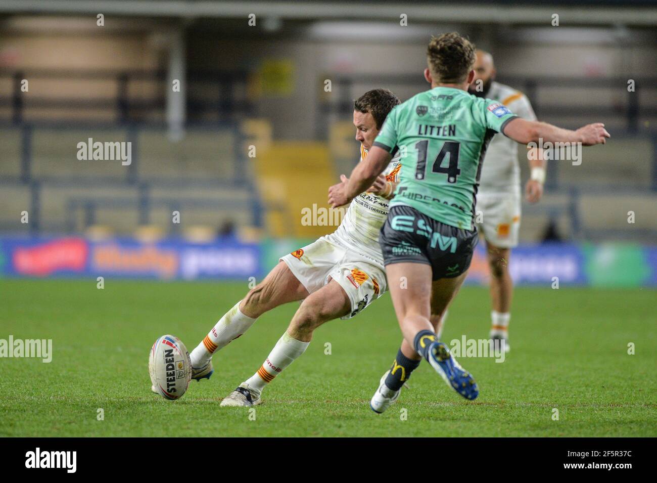 Leeds, England - 26th March 2021 - Catalan Dragons James Maloney kicks late golden point drop goal to win the match during the Rugby League Betfred Super League Round 1 Catalan Dragons vs Hull Kingston Rovers at Emerald Headingley Stadium, Leeds, UK  Dean Williams/Alamy Live News Stock Photo