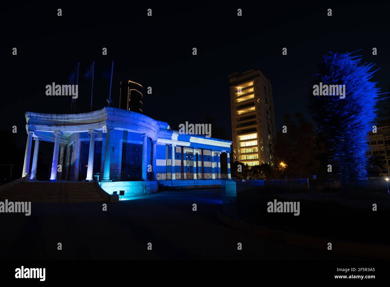 Flag of Greece illuminated in nicosia municipality building during the celebrations of Greek independence day Stock Photo