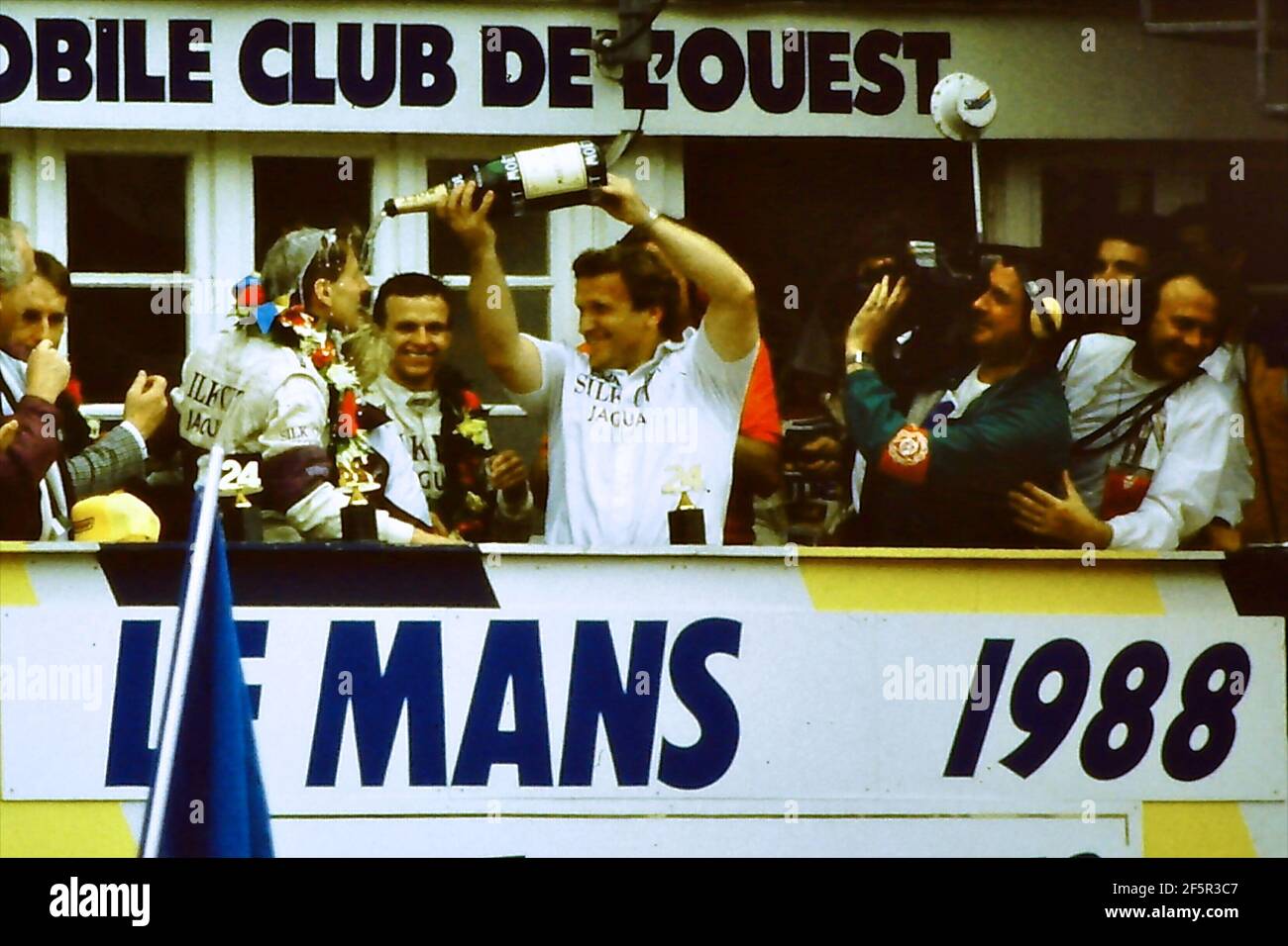 12.06.1988. Le Mans 24 Hours. Tom Walkinshaw pours champagne over driver Jonny Dumfries. Dumfries, real name John Colum Crichton-Stuart, 7th Marquis of Bute, passed away on 22nd March 2021 after a brief illness Stock Photo