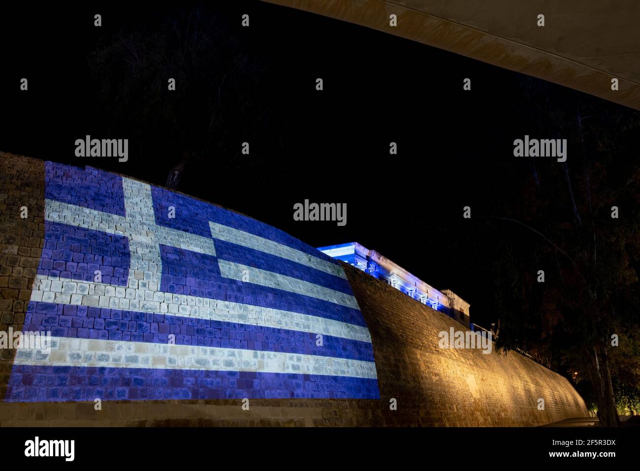 Flag of Greece illuminated in nicosia ancient wall and municipality building during the celebrations of Greek independence day Stock Photo