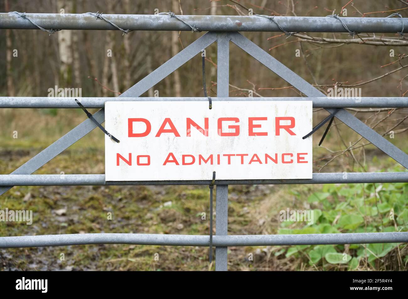 Danger no admittance entry sign on gate Stock Photo