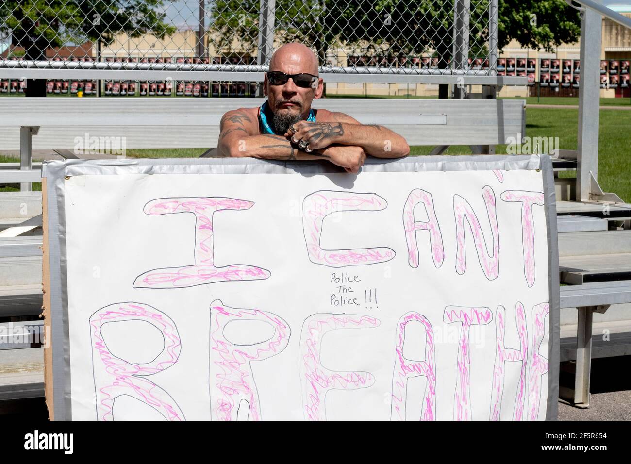 White Man at Black Lives Matter BLM Protest with I can't Breathe poster Stock Photo