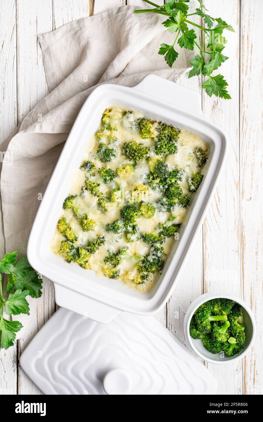 Simple broccoli and cheese casserole on white wooden background Stock Photo