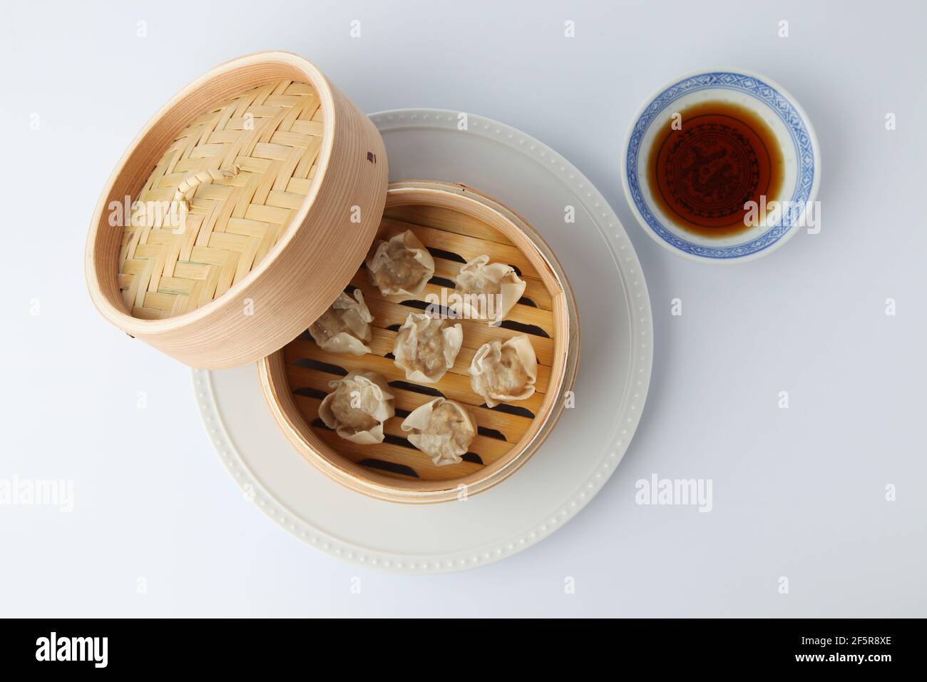 Shumai shaomai Chinese steamed meat dumpling on white background Stock Photo