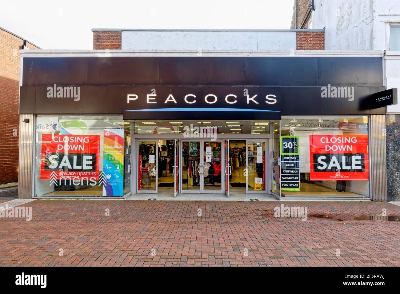 Poole, Dorset  UK - November 3 2020: Closing Down Sale posters displayed in the windows of the fast-fashion clothing retail chain store Peacocks Stock Photo