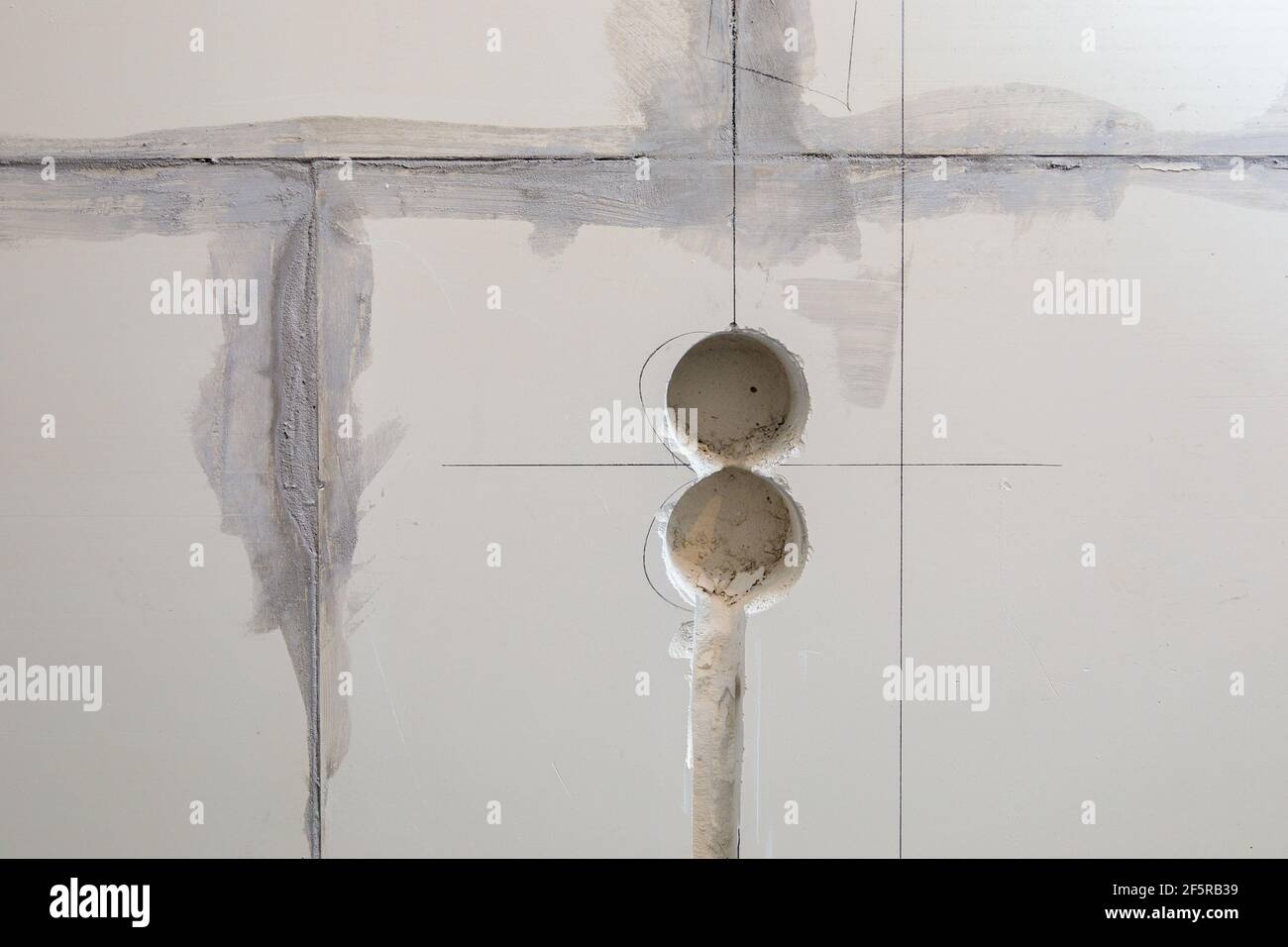 Holes in the wall for sockets. Electrical wiring in the wall. Repair, marking of sockets Stock