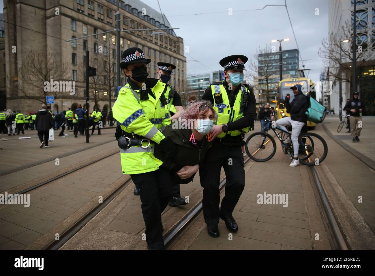 Manchester, UK. 27th March, 2021. Hundreds of protesters took to the streets in a 'Kill The Bill' demonstration.  The protesters caused hours of traffic chaos around the city centre by holding sit down protests.  Buses on Oxford Road had to be turned around and take alternative routes.  A late afternoon stand off with police occurred as the protesters blocked tram lines.  After requests to move on where ignored, the police Tactical Aid Unit moved in and grabbed several of the protesters.  Several arrests were made. Manchester, UK. Credit: Barbara Cook/Alamy Live News Stock Photo