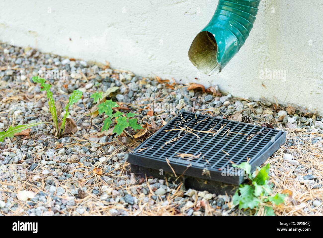 Storm sewer with grate. Rainwater drainage into the grate. How to make the drainage of the site and the drainage of water Stock Photo