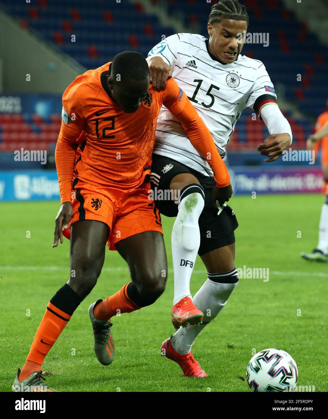 27 March 2021, Hungary, Székesfehérvár: Football, U-21 Men: European  Championship, Germany - Netherlands, Preliminary Round, Group A, Matchday 2  at Sostoi Stadion. Germany's Ismail Jakobs (r) and Jordan Teze from the  Netherlands