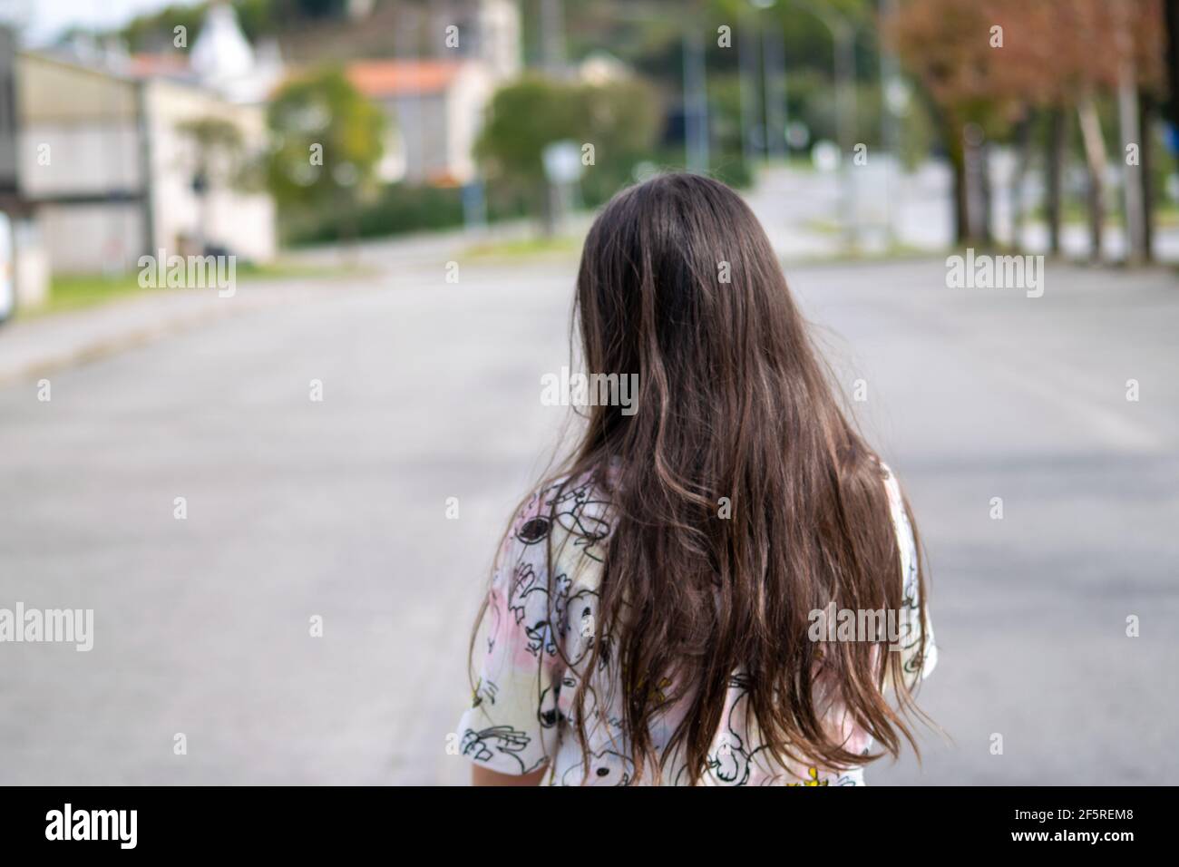 Young girl kai tai clothes and long hair walking. Kids day life without school. Stock Photo