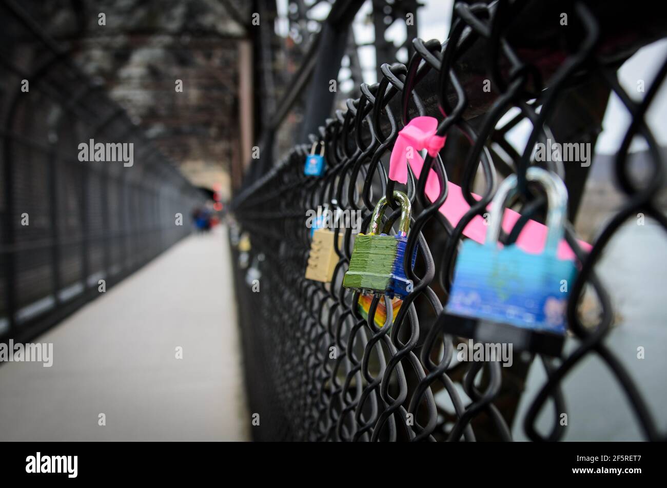 Padlocks attached to the steel fence lining the railroad bridge in Harpers Ferry National Park in West Virginia, USA Stock Photo