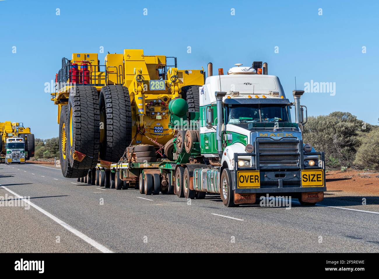 Heavy mine machinery being transported by road train trucks, Western Australia Stock Photo
